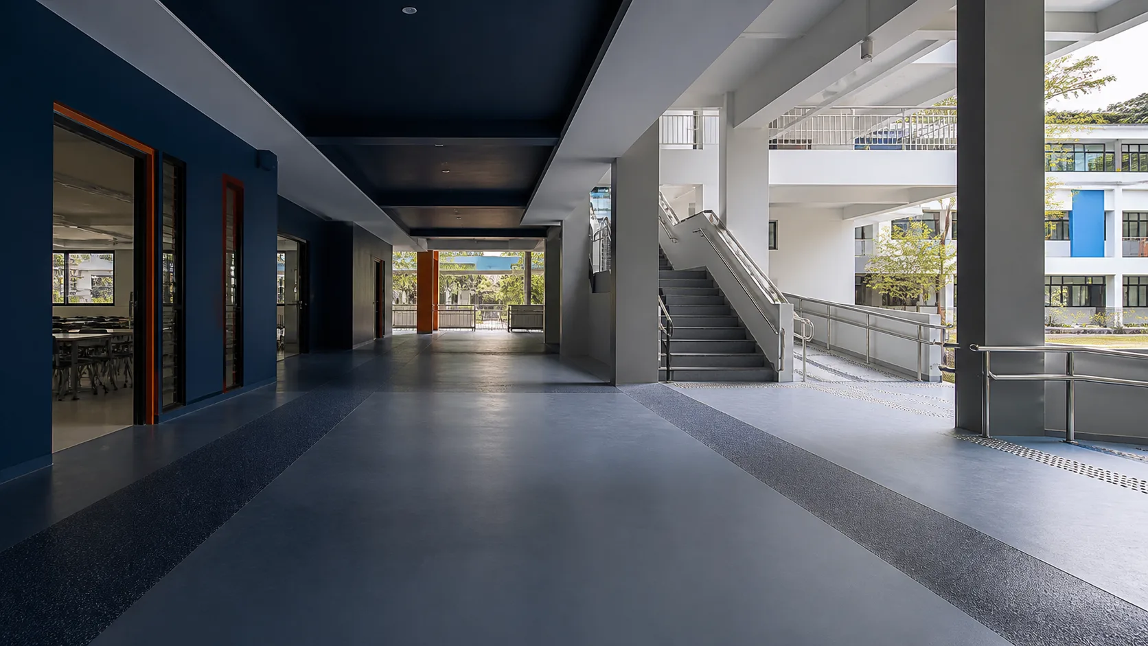 Singapore school corridor connecting classrooms, stairs and a ramp with zoned resin flooring
