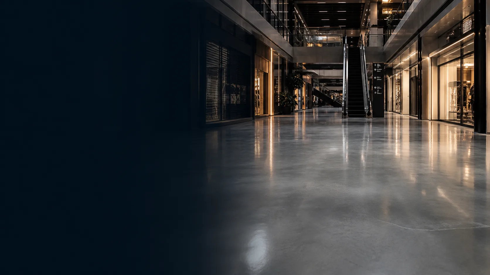 After-hours Singapore mall storefronts, concourse and grey resin floor